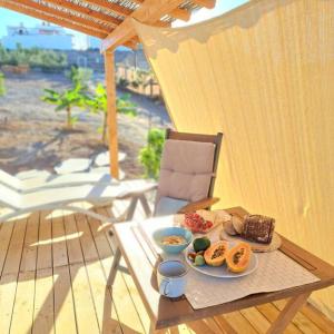 a tray of food on a table on a patio at La Pérgola Calma in San Bartolomé de Tirajana