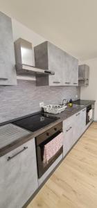 a kitchen with stainless steel cabinets and a sink at Infinity Collection in Padova