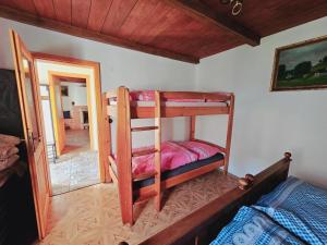 a bedroom with two bunk beds and a mirror at Stateček plný zvířátek 