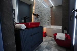 a bathroom with a red toilet and a bath tub at Vanilla 11 in Istanbul