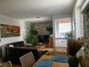 a living room with a couch and a table at Apartmán Rubicon in Poprad
