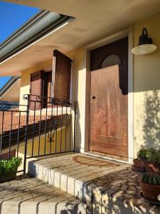 una casa con una porta in legno su un portico di Sentirsi a casa a Chiampo