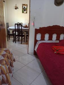 a bedroom with a bed and a dining room table at CHÁCARA TERRA dos SONHOS in Guaratinguetá