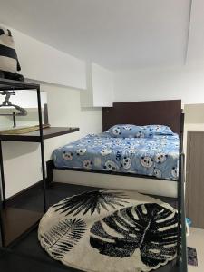 a bedroom with a bunk bed with a rug on the floor at Loft apartment bintaro in South Tangerang