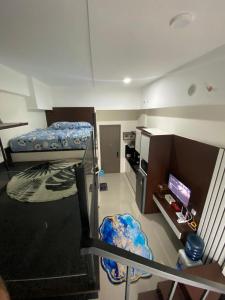 a room with two bunk beds and a kitchen at Loft apartment bintaro in South Tangerang
