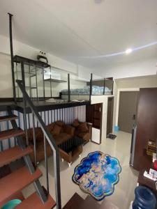 a living room with a bunk bed and a couch at Loft apartment bintaro in South Tangerang