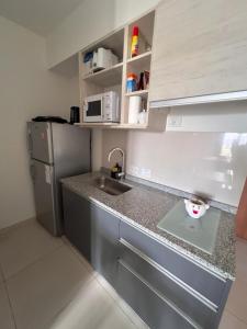 a small kitchen with a sink and a refrigerator at DEPARTAMENTO Solar in Resistencia +2 photos