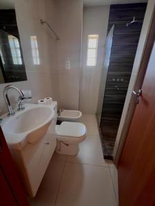 a bathroom with a sink and a toilet and a shower at DEPARTAMENTO SOLAR con COCHERA in Resistencia +2 photos