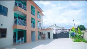 a building with balconies on the side of it at Extended Stay Suite, Tema. in Tema
