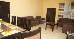 a living room with a couch and a table at Extended Stay Suite, Tema. in Tema