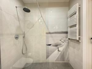 a shower with a glass door with a bird on the wall at Old Town Nadmotławie - Sauna & Gym I 10min deptak in Gdańsk