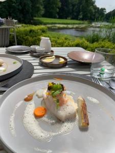 a white plate with food on a table at Private House ‘Het Dwerghuys’ - also longstays in Doorn