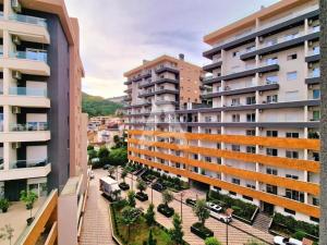 an apartment building with a courtyard in front of it at KAAN APARTMENT in Budva