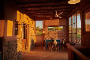 a room with a table and chairs in a building at Casa Chincol in San Pedro de Atacama