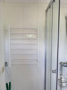 a shower with a glass door in a bathroom at Заміський комплекс відпочинку Bochka in Khotinovka