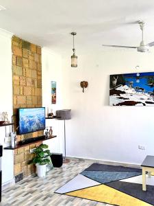 a living room with a tv on a wall at Unique apartment 2 in Mombasa