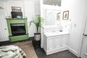 a bathroom with a sink and a fireplace at Walnut Street Inn in Springfield +24 photos