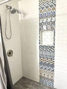 a bathroom with a shower with a tile wall at Private cozy cabin in the woods with great view in Murphy