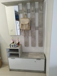 a room with a counter with a purse and a mirror at ATLANTERRA PUEBLO in Zahara de los Atunes