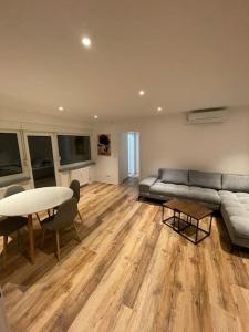 a living room with a couch and a table at Penthouse, Offenburg,Europapark in Offenburg
