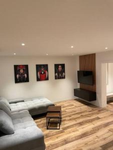 a living room with a couch and a flat screen tv at Penthouse, Offenburg,Europapark in Offenburg