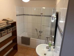 a bathroom with a shower and a sink and a tub at Le cordonnier du Staedel in La Petite-Pierre