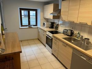 a kitchen with a sink and a stove top oven at Le cordonnier du Staedel in La Petite-Pierre +13 photos