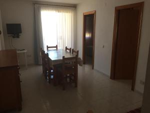 a dining room with a table and chairs and a window at Apartamentos Vicent in Peñíscola