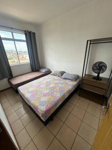 a bedroom with a bed and a window at Pampulha 2 quartos completo in Belo Horizonte