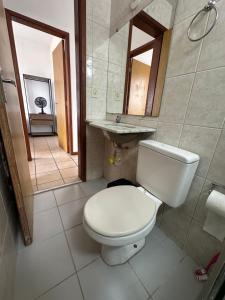 a bathroom with a toilet and a sink at Pampulha 2 quartos completo in Belo Horizonte