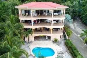 an aerial view of a house with a swimming pool at Magical 1 Bedroom Condo with Ocean View & Pool in Potrero