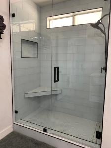 a shower with a glass door in a bathroom at Casa Del Desierto - Panoramic Views - Pet Friendly - Fire Pit in Joshua Tree