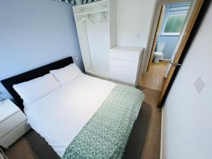 um pequeno quarto com uma cama e uma janela em 2 Bedroom Chalet SB57, Sandown, Isle of Wight em Brading