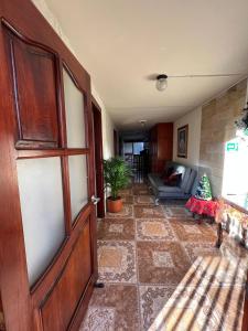a living room with a door and a couch at HOSTAL LA CASA DE LOS SUEÑOS in Jardin
