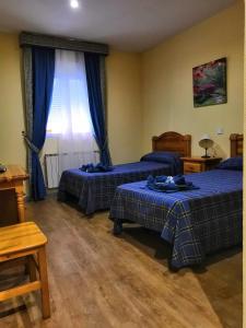 Postel nebo postele na pokoji v ubytování Hostal Hotel EL Chato