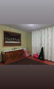 a room with a bed and a dresser and a window at Sítio casa grande in São Gonçalo do Amarante