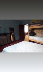 a bedroom with two bunk beds and a mirror at Sítio casa grande in São Gonçalo do Amarante