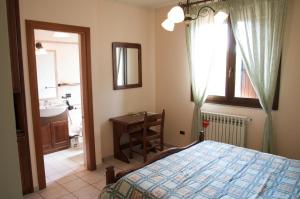 1 dormitorio con 1 cama y baño con lavamanos en Azienda Agrituristica Salella, en Salento