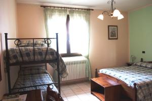 A bed or beds in a room at Azienda Agrituristica Salella