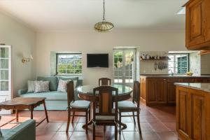 a living room with a table and a couch at Quinta das Casas - Douro Winery & Villas in Vila Real