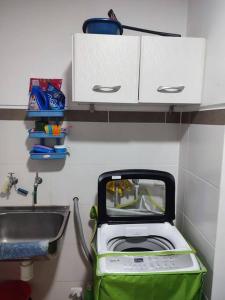 a small kitchen with a sink and a toaster at Departamento con excelente vista de la ciudad in Tarija