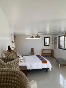 een slaapkamer met een bed en een stoel erin bij Loft la herradura in Coquimbo