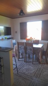 a living room with a dining room table and chairs at Aluga-se apartamento em Ponta de Areia in Itaparica Town