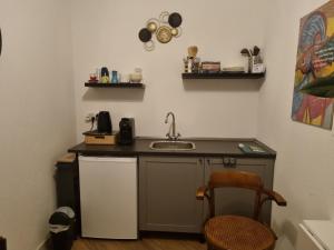 a small kitchen with a sink and a counter at Haardstee in Borger