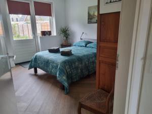 a bedroom with a bed with two towels on it at Haardstee in Borger