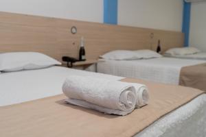 a room with two beds with towels on them at Suite and Business in Pucallpa