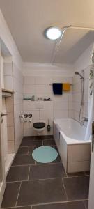 a bathroom with a tub and a toilet and a sink at Wohnung zum Wohlfühlen beruflich und privat in Zell am Main