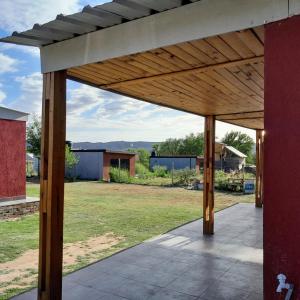 a large wooden pergola on top of a yard at AYRES DE MONTAÑA in San Ignacio