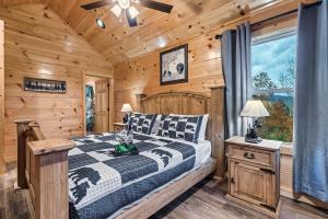 a bedroom with a bed in a log cabin at cul-de-sac Log Cabin, Hot-Tub, Arcade Games, In-Built Bunk beds, Level2 EV On site in Pigeon Forge