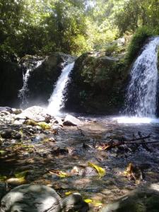 a waterfall in the middle of a river at Bunga Maliq Bungalow Lombok in Tetebatu